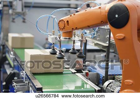 Robotic arm on a production line View Large Photo Image Picture - Robotic arm on a production line. Fotosearch