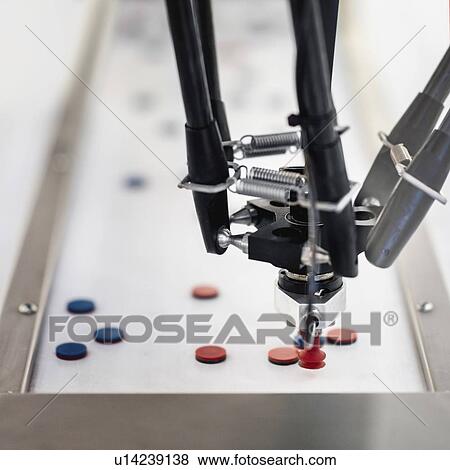 Stock Photo - Robotic handling machine for pharmaceutical industry. Fotosearch