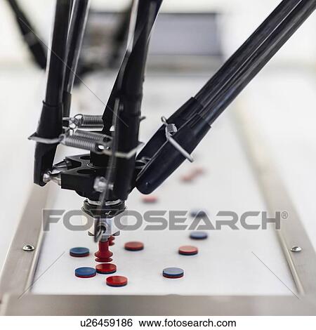 Stock Photograph - Robotic handling machine for pharmaceutical industry. Fotosearch