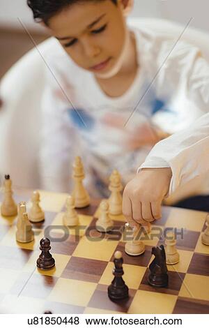 Schoolboy playing chess View Large Photo Image Stock Photo - Schoolboy playing chess. Fotosearch