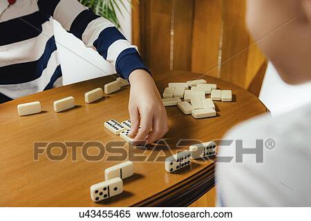 Schoolboy playing dominoes View Large Photo Image Stock Photography - Schoolboy playing dominoes. Fotosearch