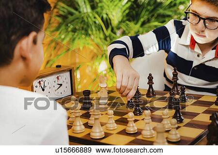 Stock Photo - Schoolboys playing chess. Fotosearch
