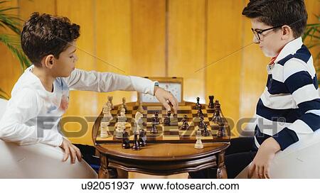 Stock Photo - Schoolboys playing chess. Fotosearch