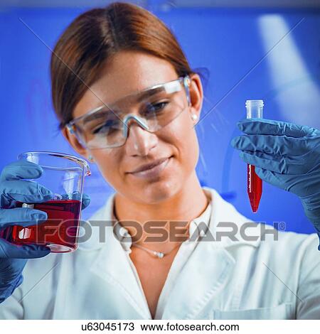 Stock Image - Scientist examining sample. Fotosearch