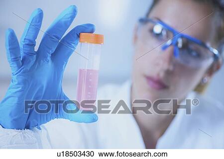 Scientist holding liquid sample View Large Photo Image Stock Image - Scientist holding liquid sample. Fotosearch