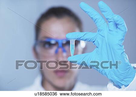 Scientist holding micro test tube View Large Photo Image Stock Photograph - Scientist holding micro test tube. Fotosearch