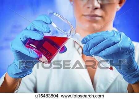 Scientist pouring sample View Large Photo Image Picture - Scientist pouring sample. Fotosearch