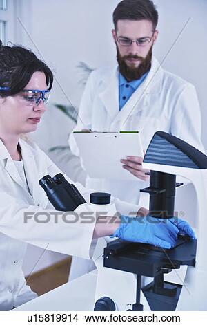 Scientist using microscope View Large Photo Image Picture - Scientist using microscope. Fotosearch