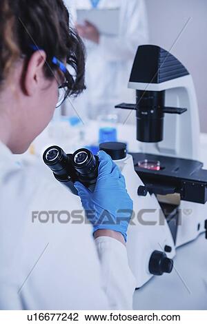 Scientist using microscope View Large Photo Image Stock Image - Scientist using microscope. Fotosearch