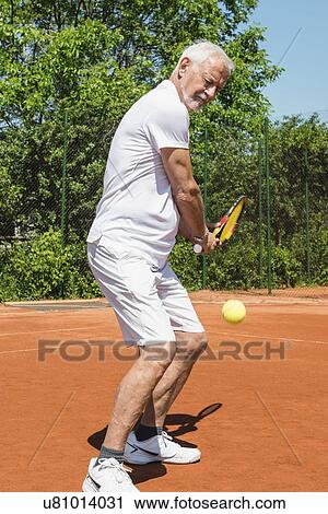 Senior man playing tennis View Large Photo Image Stock Image - Senior man playing tennis. Fotosearch
