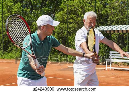 Senior man with tennis instructor View Large Photo Image Stock Image - Senior man with tennis instructor. Fotosearch