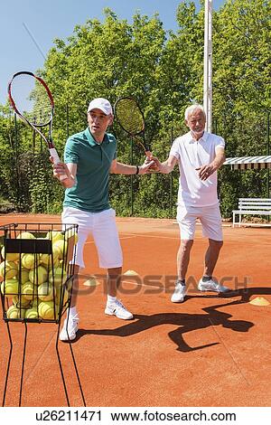 Senior man with tennis instructor View Large Photo Image Stock Image - Senior man with tennis instructor. Fotosearch