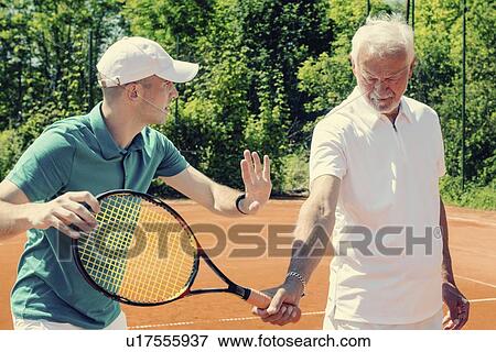 Senior man with tennis instructor View Large Photo Image Stock Photo - Senior man with tennis instructor. Fotosearch