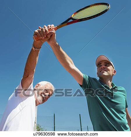 Stock Photo - Senior man with tennis instructor. Fotosearch