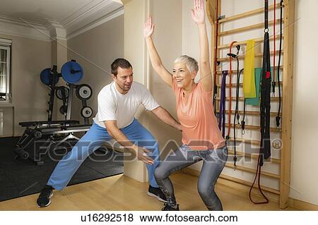 Stock Photo - Senior woman doing squats. Fotosearch