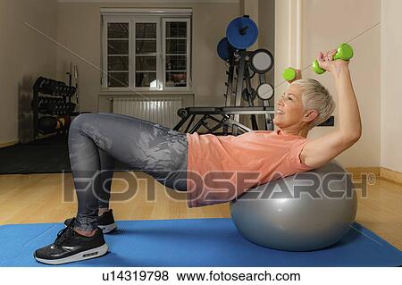 Senior woman exercising on pilates ball View Large Photo Image Stock Photo - Senior woman exercising on pilates ball. Fotosearch