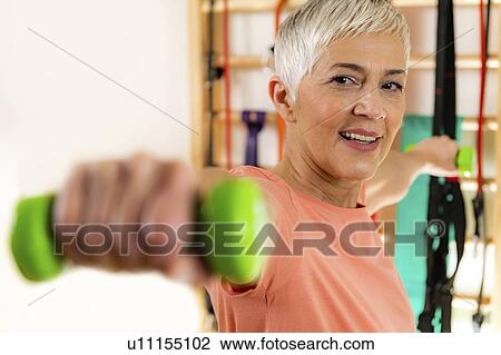 Stock Image - Senior woman exercising. Fotosearch