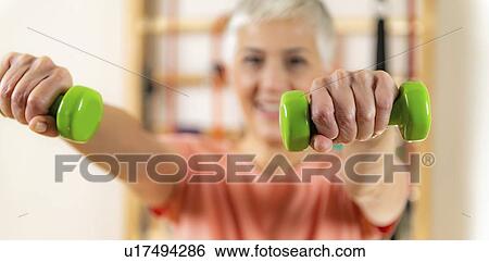 Stock Photograph - Senior woman exercising. Fotosearch