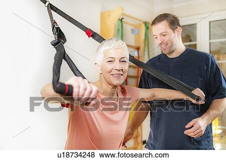 Stock Photo - Senior woman with personal trainer. Fotosearch