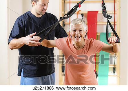 Stock Photograph - Senior woman with personal trainer. Fotosearch