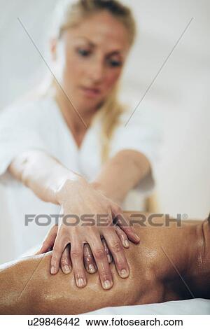 Stock Image - Shoulder massage. Fotosearch