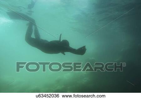 Stock Photograph - Silhouette of a free diver. Fotosearch