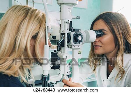 Stock Image - Slit lamp eye examination. Fotosearch