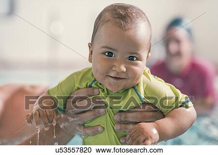 Stock Image - Smiling baby swimming. Fotosearch