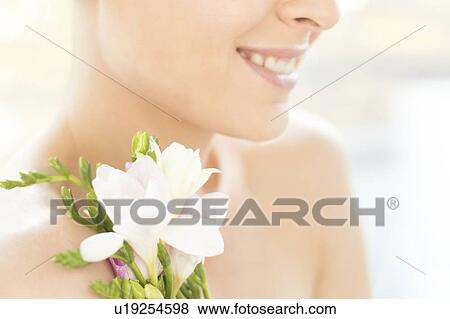 Smiling woman holding flowers View Large Photo Image Stock Photo - Smiling woman holding flowers. Fotosearch