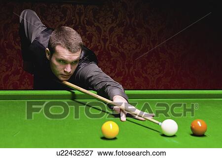 Stock Photo - Snooker player taking a shot. Fotosearch