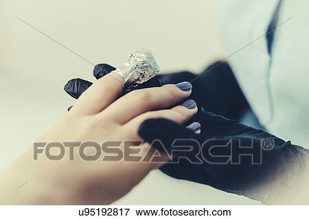 Stock Photo - Soaking off gel manicure. Fotosearch