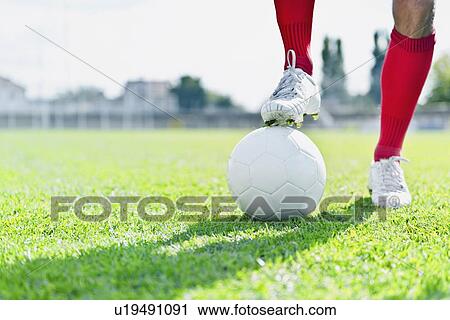Stock Image - Soccer player and ball. Fotosearch