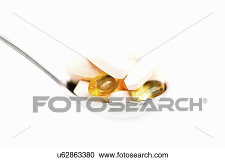 Stock Image - Spoonful of supplements. Fotosearch