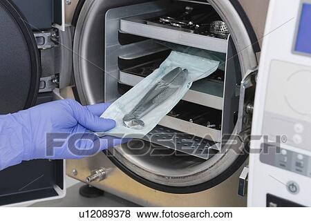 Stock Photo - Sterilizing medical instruments in autoclave. Fotosearch