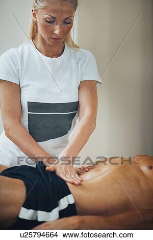 Stomach massage View Large Photo Image Picture - Stomach massage. Fotosearch