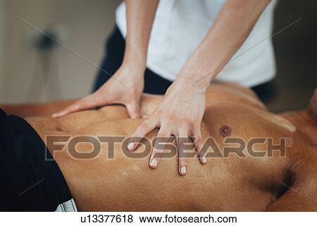 Stomach massage View Large Photo Image Stock Photo - Stomach massage. Fotosearch