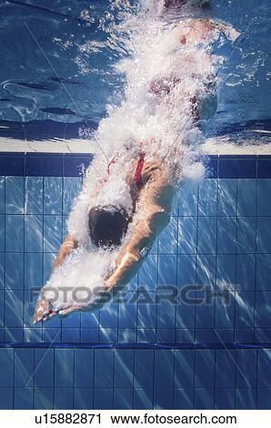 Swimmer diving into pool View Large Photo Image Stock Image - Swimmer diving into pool. Fotosearch