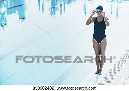 Stock Image - Swimmer next to pool. Fotosearch