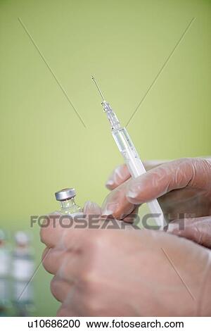 Stock Image - Syringe and vaccine vial. Fotosearch