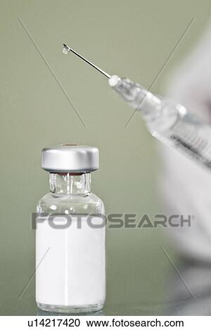 Stock Image - Syringe and vaccine vial. Fotosearch