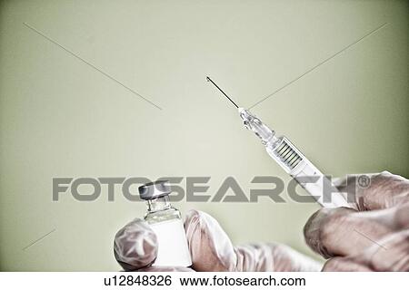 Stock Photograph - Syringe and vaccine vial. Fotosearch