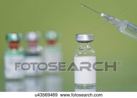 Stock Photo - Syringe and vaccine vials. Fotosearch