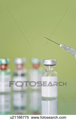 Stock Photography - Syringe and vaccine vials. Fotosearch