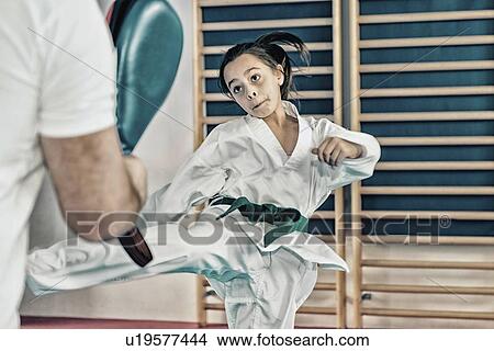 Taekwondo instructor working with girl View Large Photo Image Picture - Taekwondo instructor working with girl. Fotosearch
