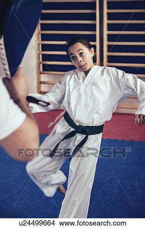 Picture - Taekwondo instructor working with girl. Fotosearch