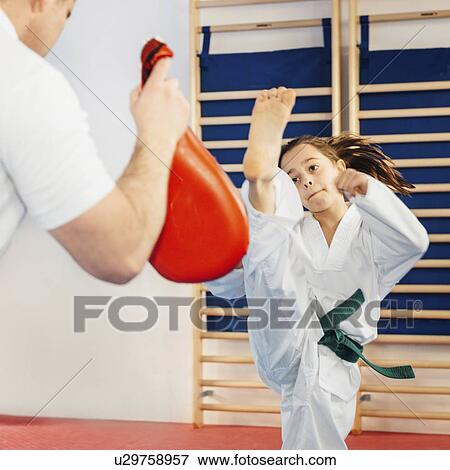 Taekwondo instructor working with girl View Large Photo Image Stock Photo - Taekwondo instructor working with girl. Fotosearch
