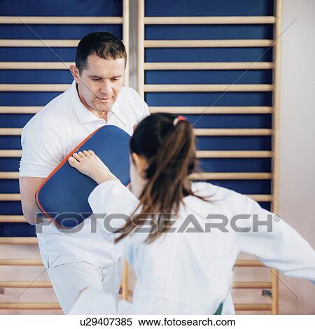 Stock Photography - Taekwondo instructor working with girl. Fotosearch