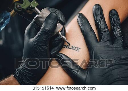 Tattoo artist at work View Large Photo Image Picture - Tattoo artist at work. Fotosearch