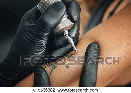 Tattoo artist at work View Large Photo Image Stock Image - Tattoo artist at work. Fotosearch