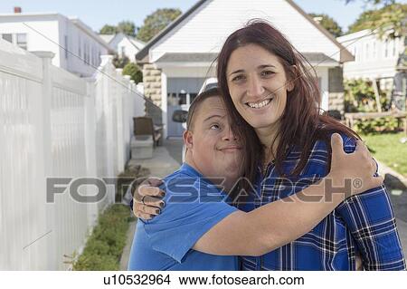 Teen who has Down Syndrome with his friend View Large Photo Image Picture - Teen who has Down Syndrome with his friend. Fotosearch